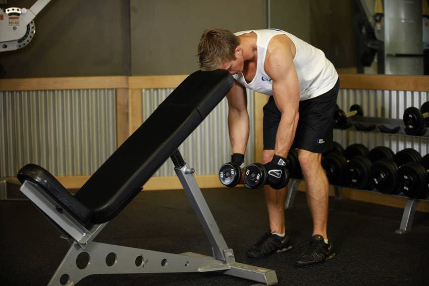 Bent Over Dumbbell Rear Delt Raise With Head On Bench, start