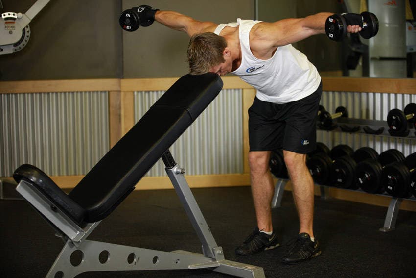 Bent Over Dumbbell Rear Delt Raise With Head On Bench, end