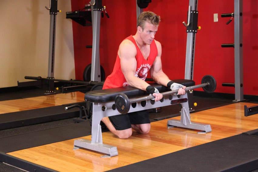 Palms-Up Barbell Wrist Curl Over A Bench, start